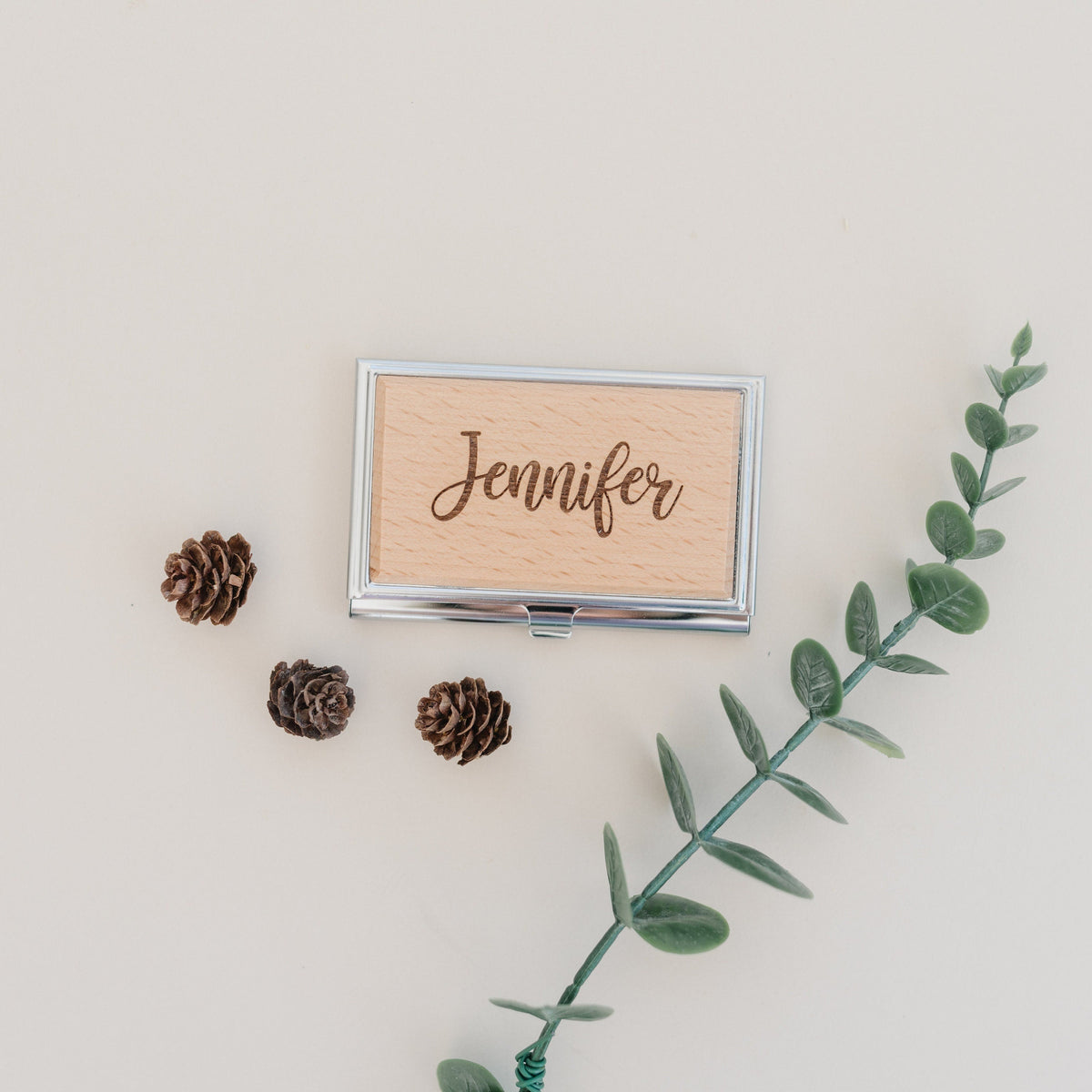 Personalized engraved card holder showing “Jennifer” in a silver metal frame
