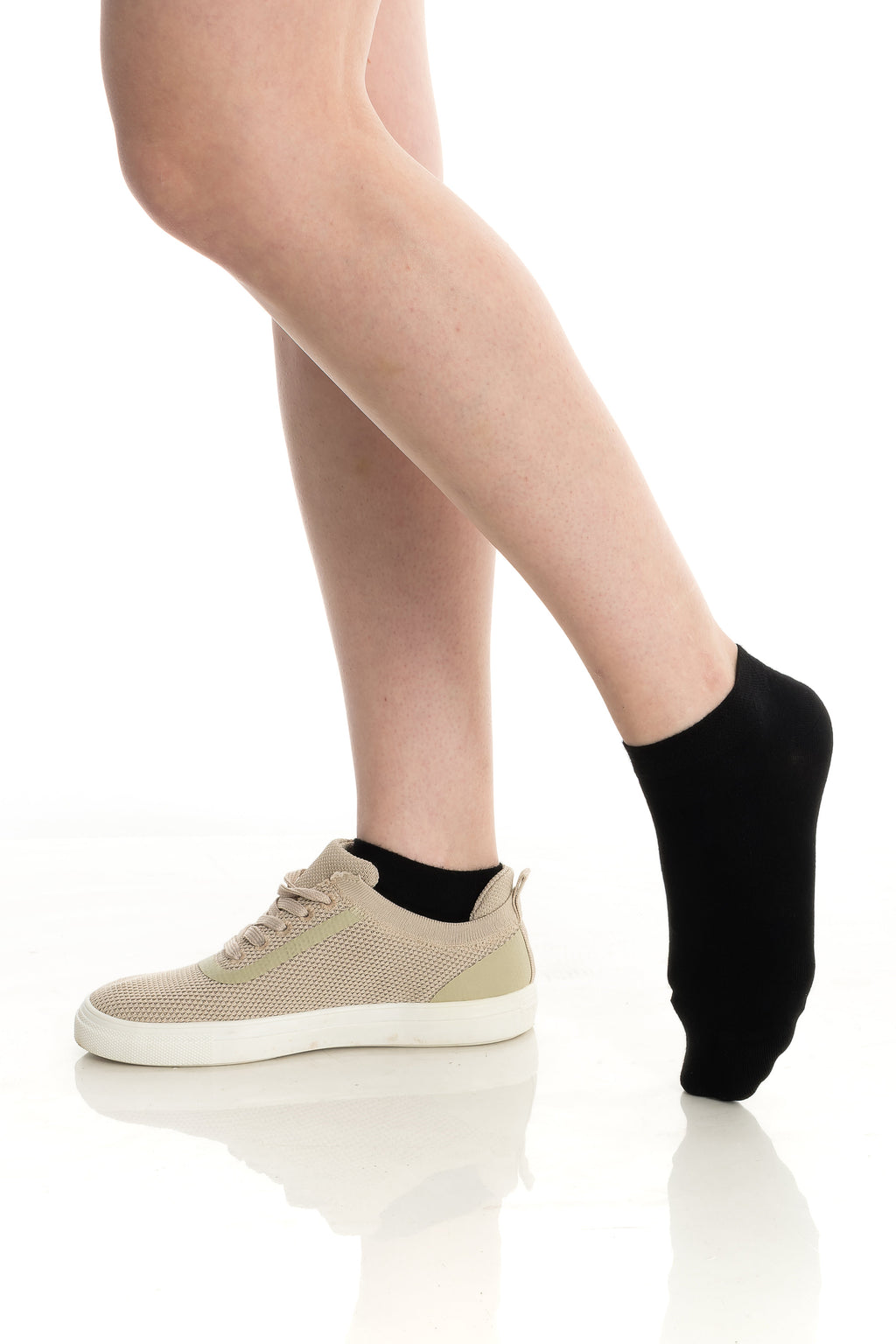 Ankle socks in black and nude on feet with sneakers