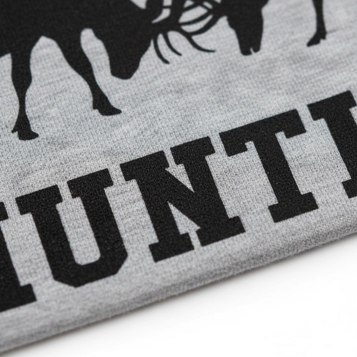 Close-up of black hunting text print on a gray T-shirt