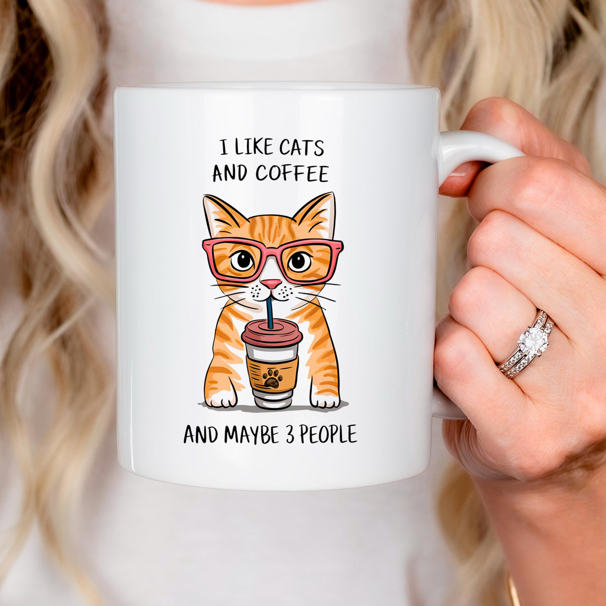 Ceramic cat coffee mug with orange tabby cat holding a drink, text 'I like cats and coffee'