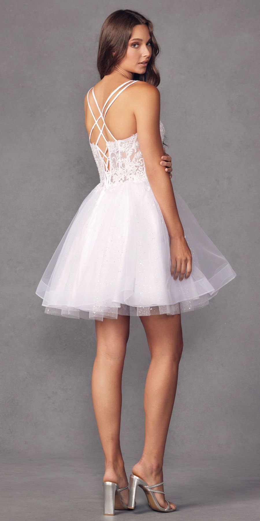 White tulle A-line dress with crisscross open back straps and glitter bodice