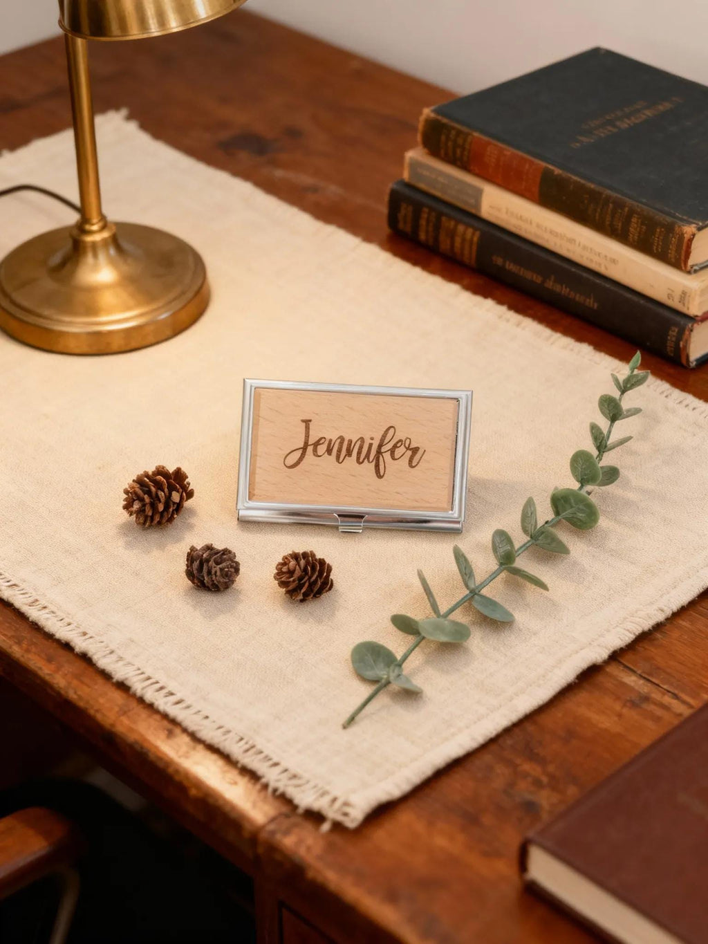 Engraved card holder with “Jennifer” in a silver frame on a tabletop stand