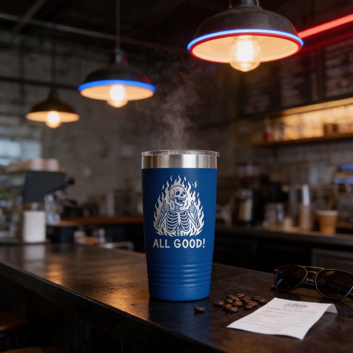 Blue insulated travel tumbler with stainless lid and white “All Good!” skeleton graphic