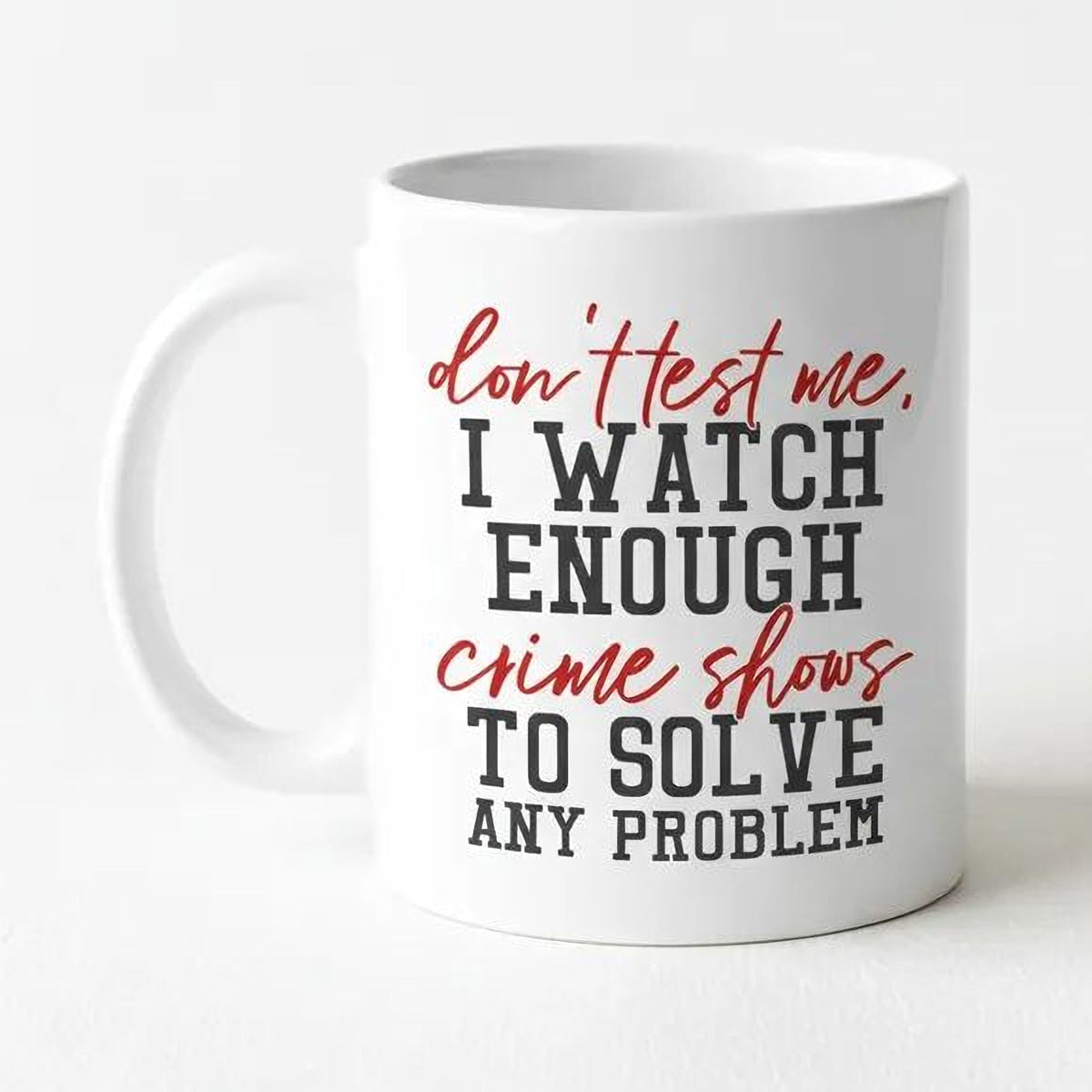White coffee mug with humorous 'I WATCH ENOUGH...' crime shows quote on front