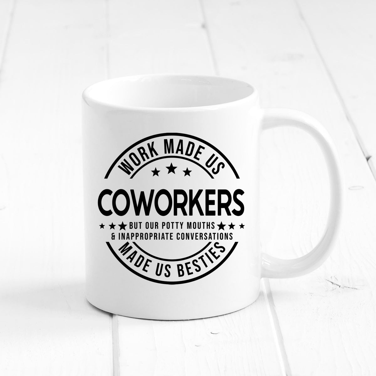 White ceramic mug with black “COWORKERS” quote graphic centered on front