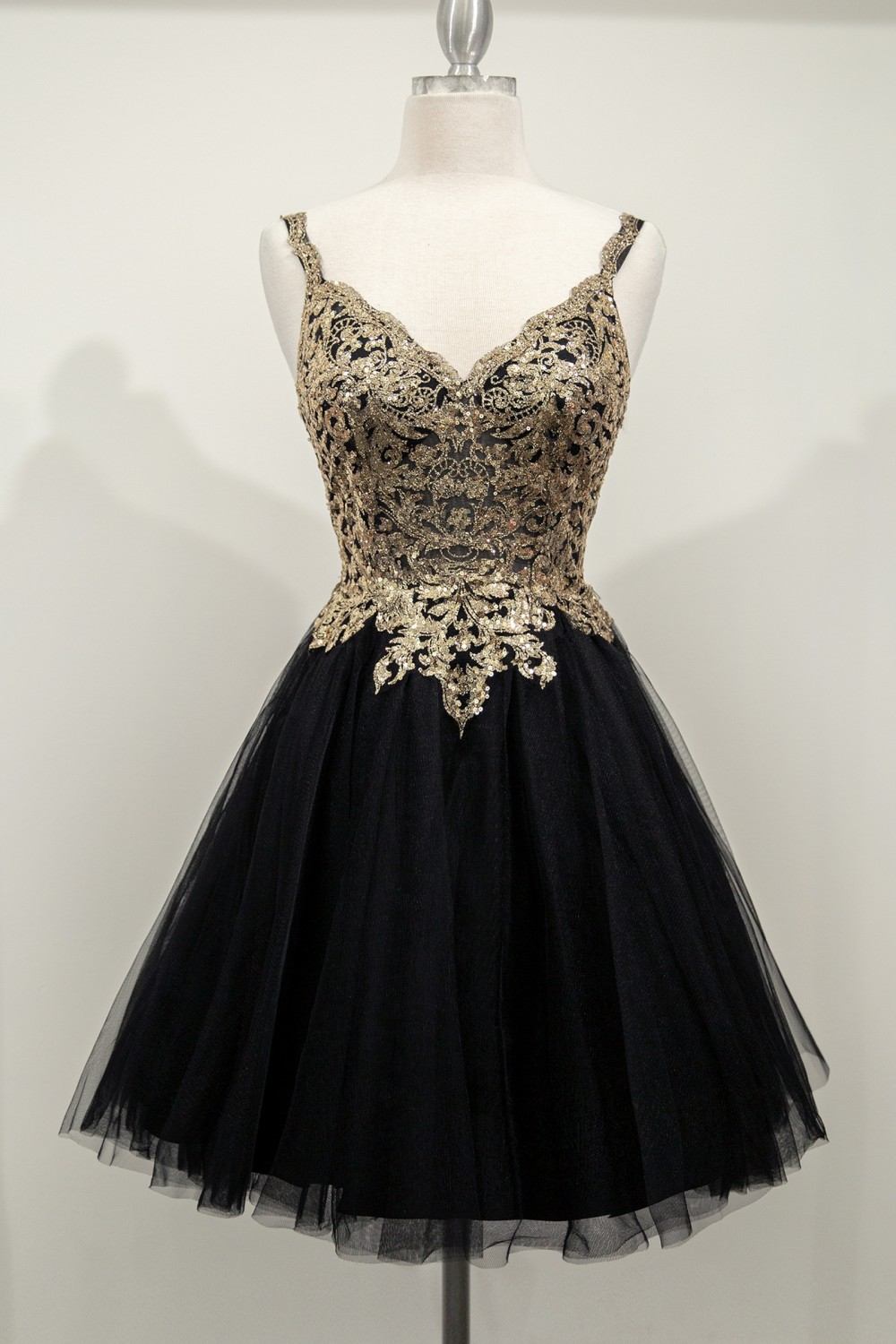 Black tulle short A-line gown with ornate gold sequin corset bodice