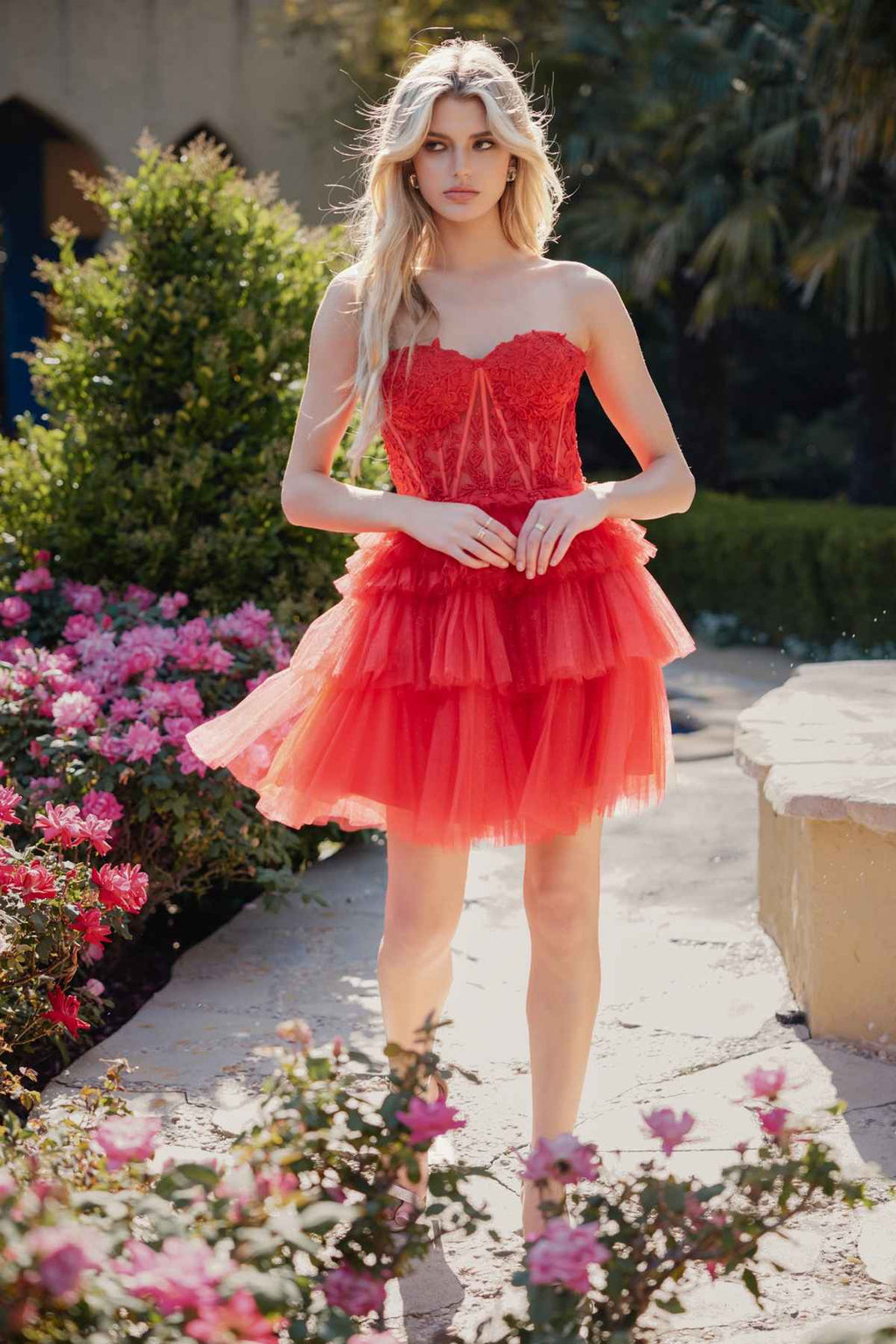 Front-view red strapless corset dress with lace bodice and layered tulle ruffle skirt