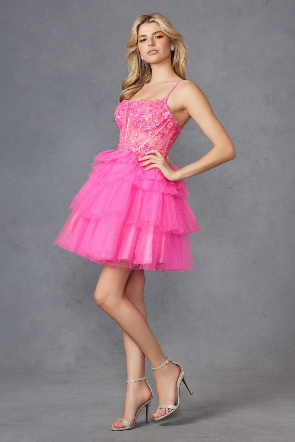 Hot pink corset-style tulle ruffle cocktail dress with tiered tulle skirt and spaghetti straps