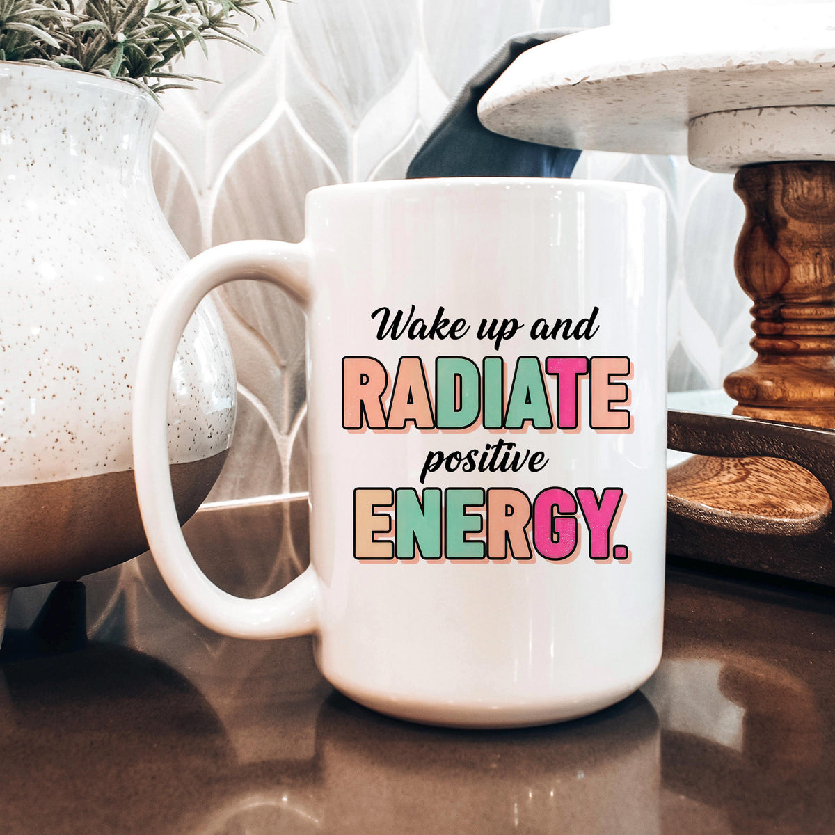 White ceramic coffee mug with “Wake up and RADIATE positive ENERGY” quote