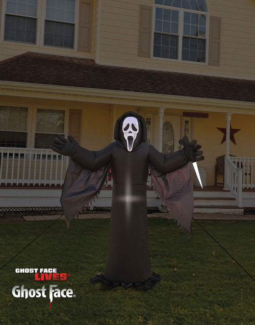 Black inflatable ghost yard figure with skull mask and open arms, bright center glow