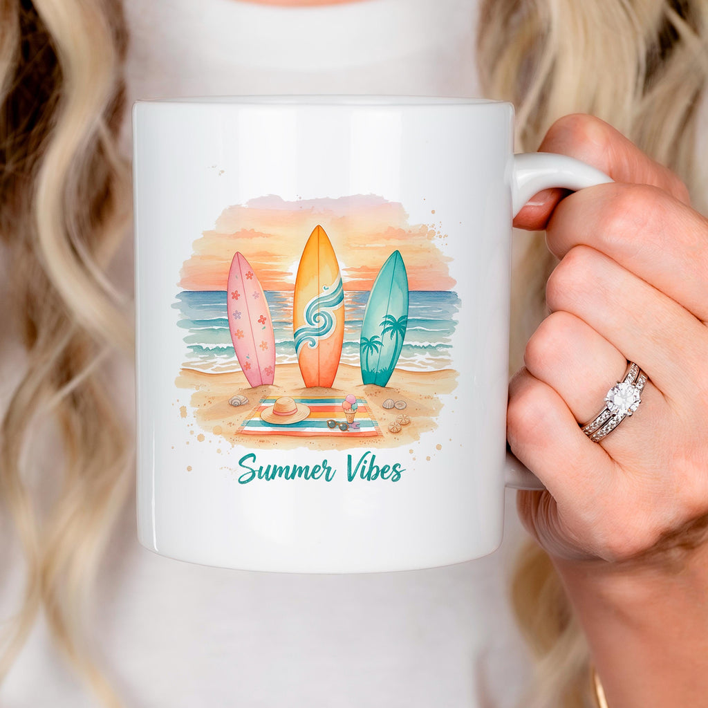 White ceramic mug with colorful surfboard beach illustration and 'Summer Vibes' text