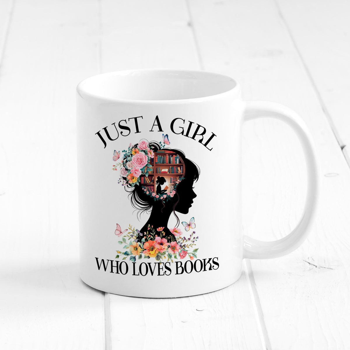 White ceramic coffee mug with “JUST A GIRL WHO LOVES BOOKS” design, side view.