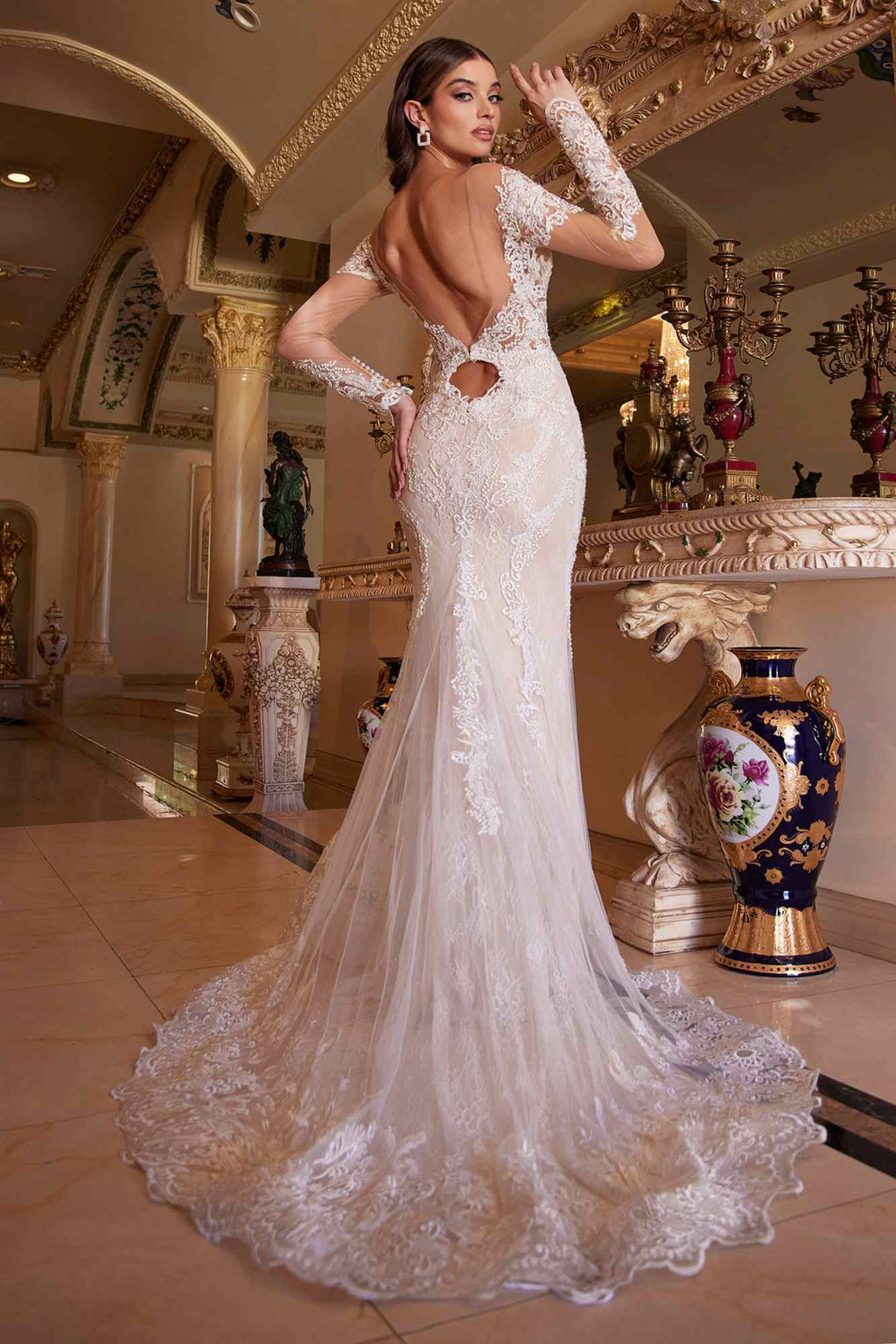 Off-white lace mermaid gown with deep open-back detail and long illusion sleeves