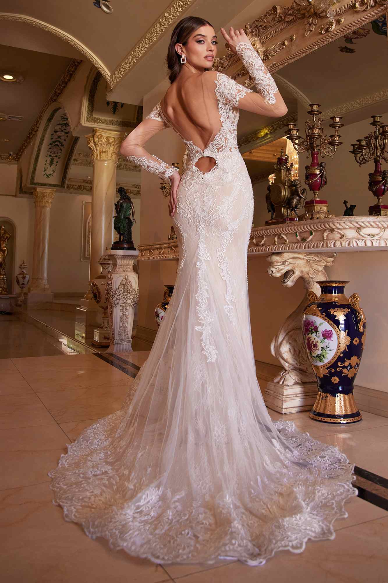 Off-white lace mermaid gown with deep open-back detail and long illusion sleeves