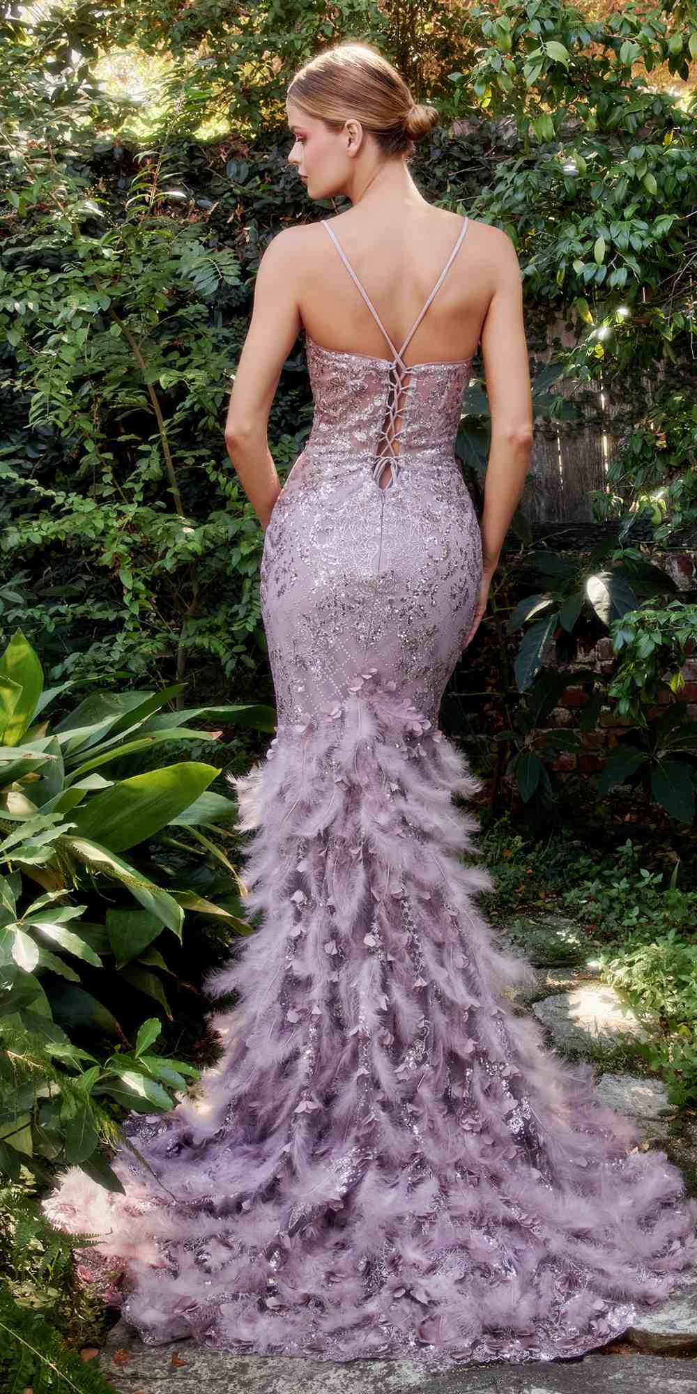 Lavender feathered mermaid gown from back view with thin straps and tiered feather hem.