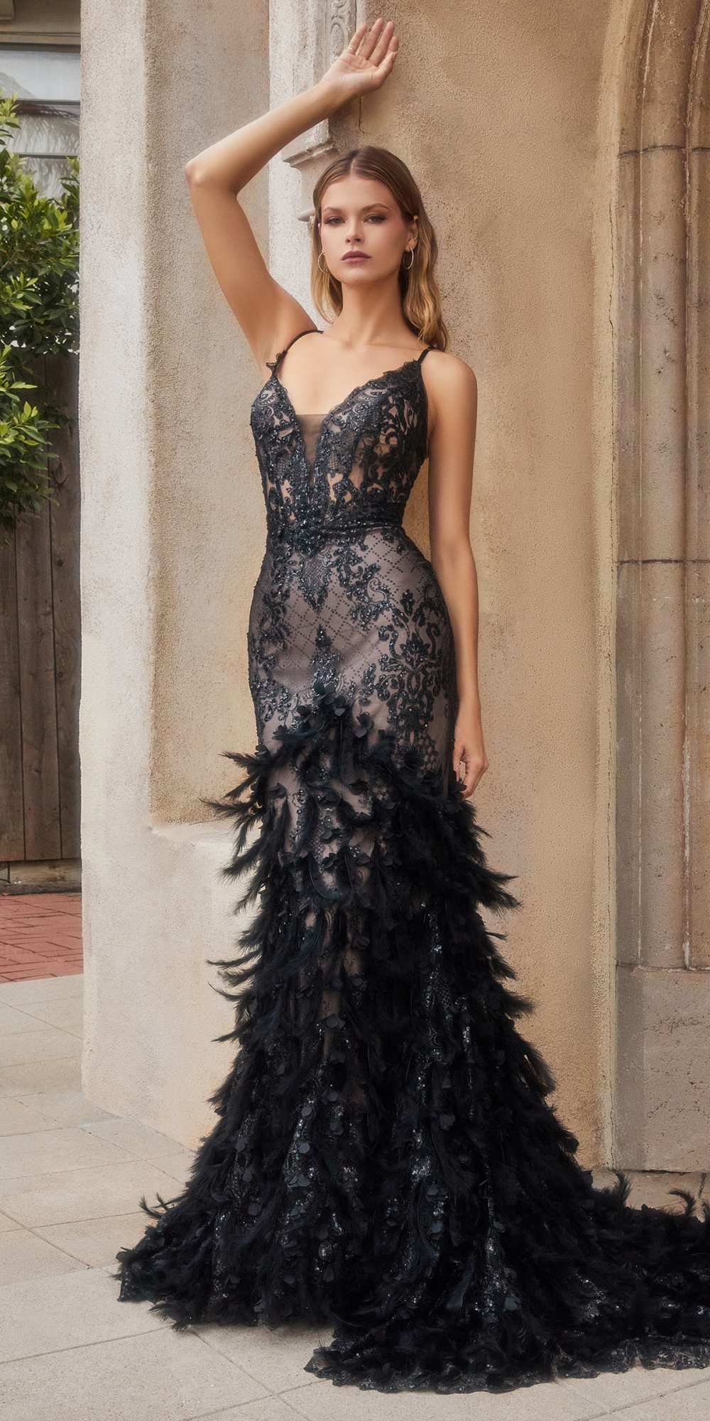 Black feathered mermaid gown with V-neck and spaghetti straps, sheer lace bodice.