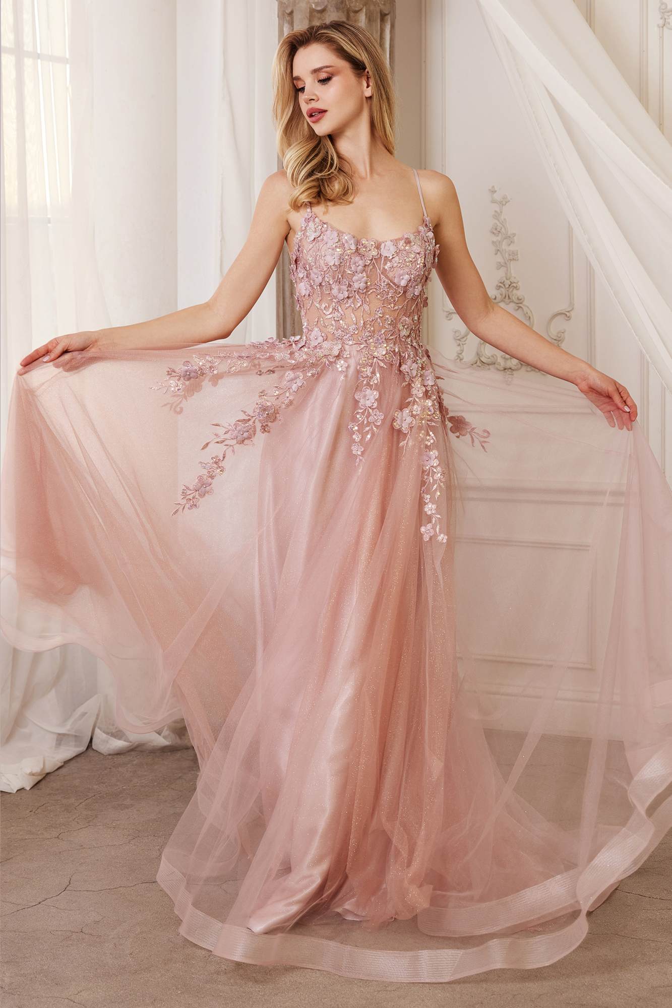 Dusty rose floral applique tulle A-line gown with thin straps and flowing skirt.