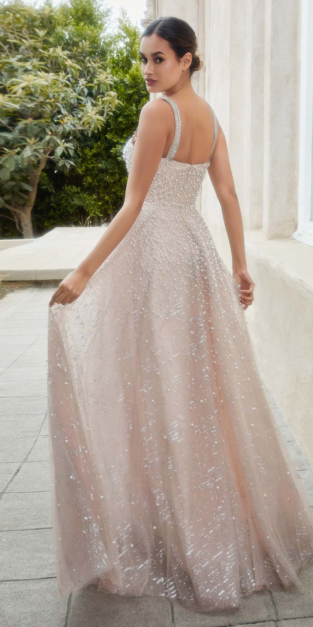 Blush ball gown with crystal straps and full glittery skirt, side view