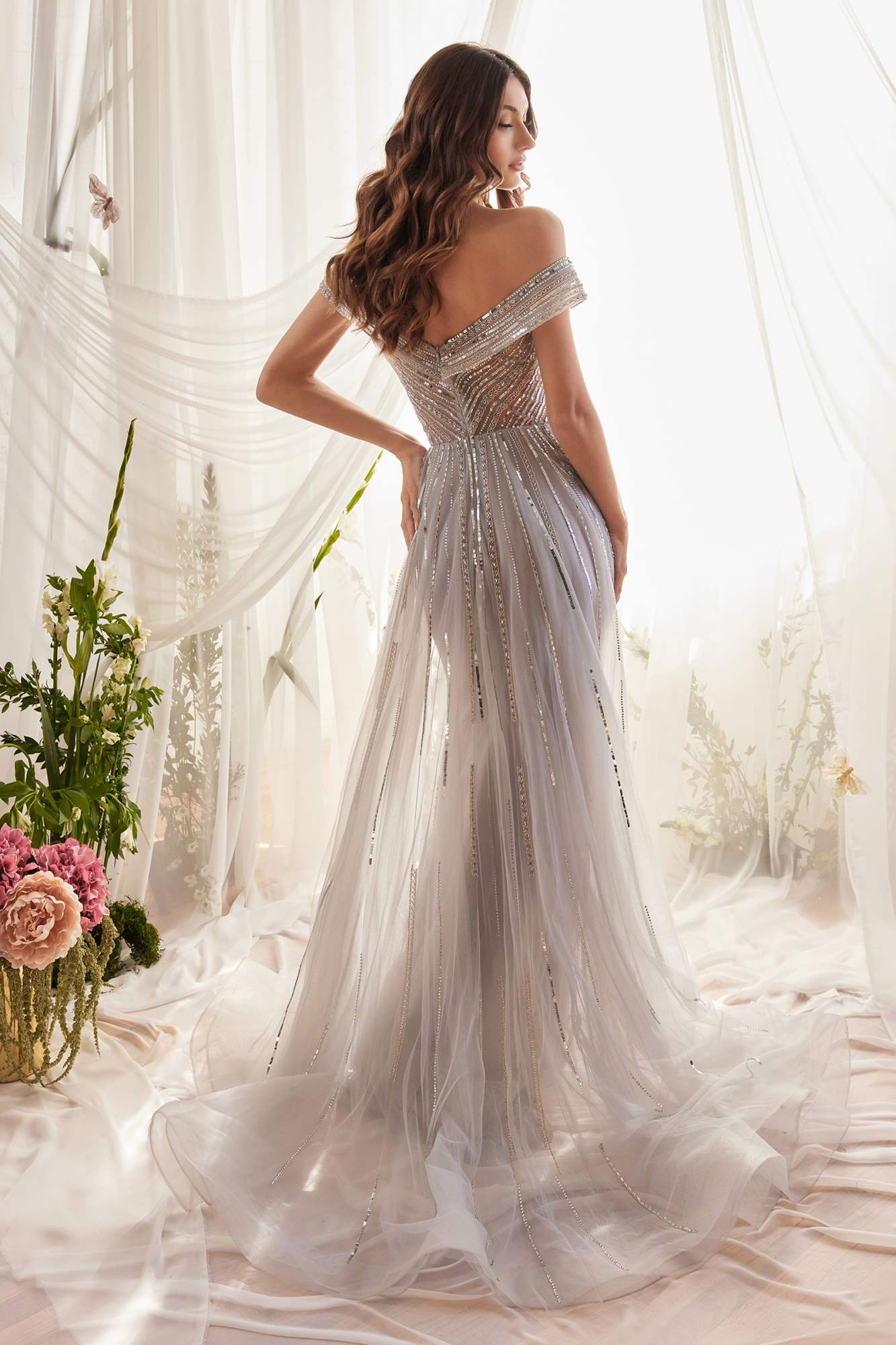 Silver off-shoulder beaded gown with fitted waist and flowing tulle train