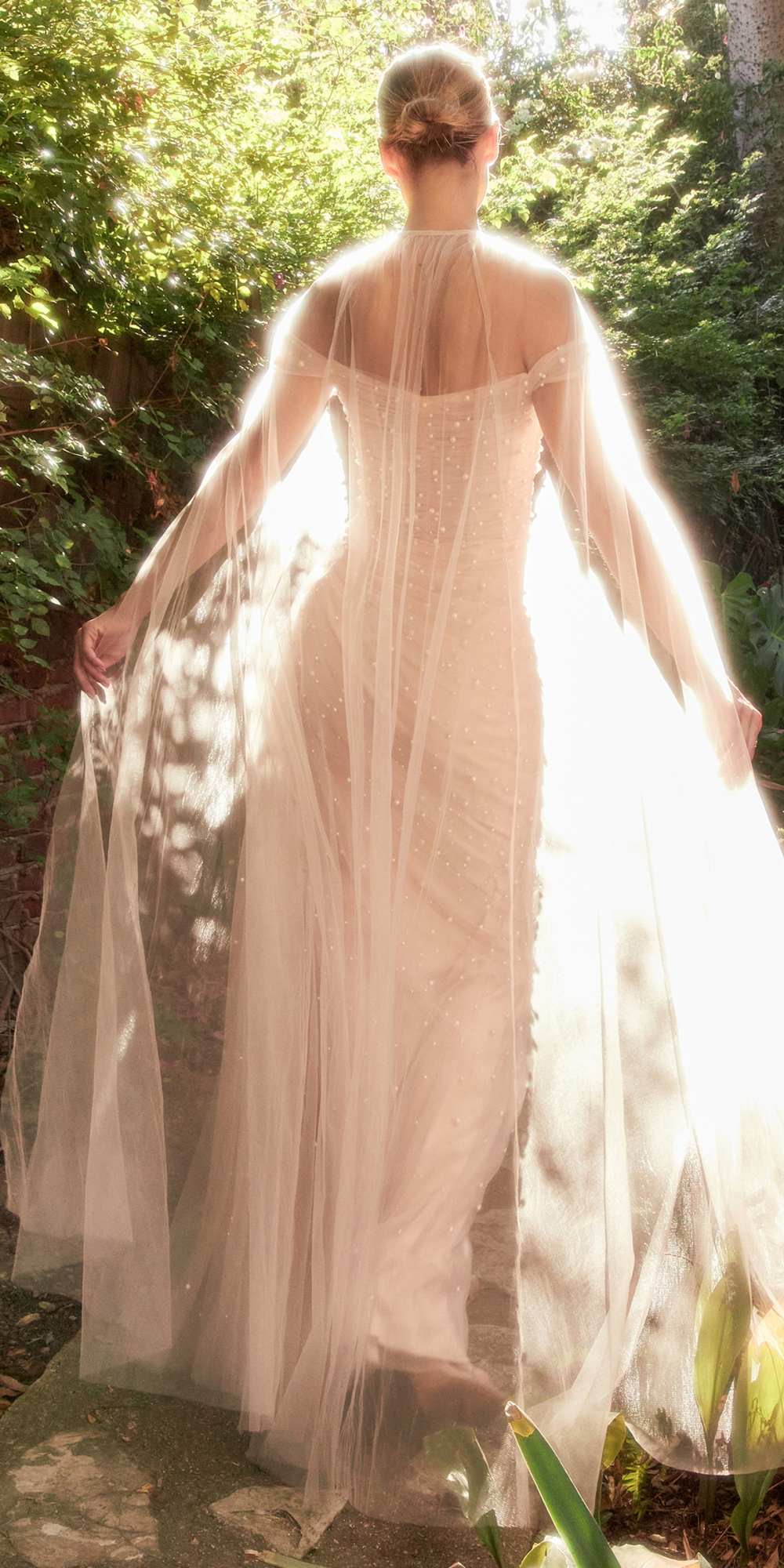 Blush pink pearl tulle floor-length gown with sheer draped back cape