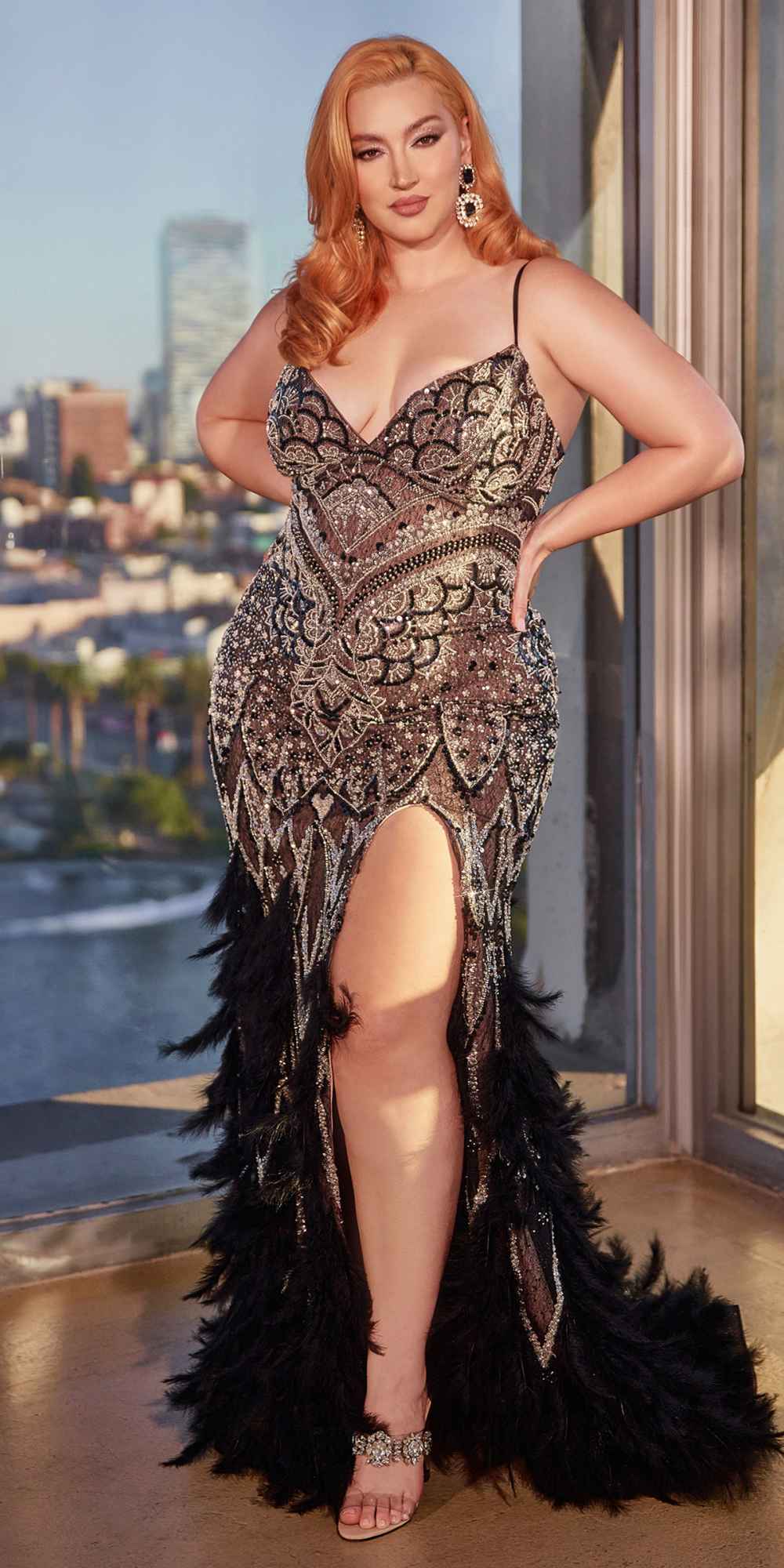 Black lace mermaid gown with beaded pattern, thigh slit, and feathered train