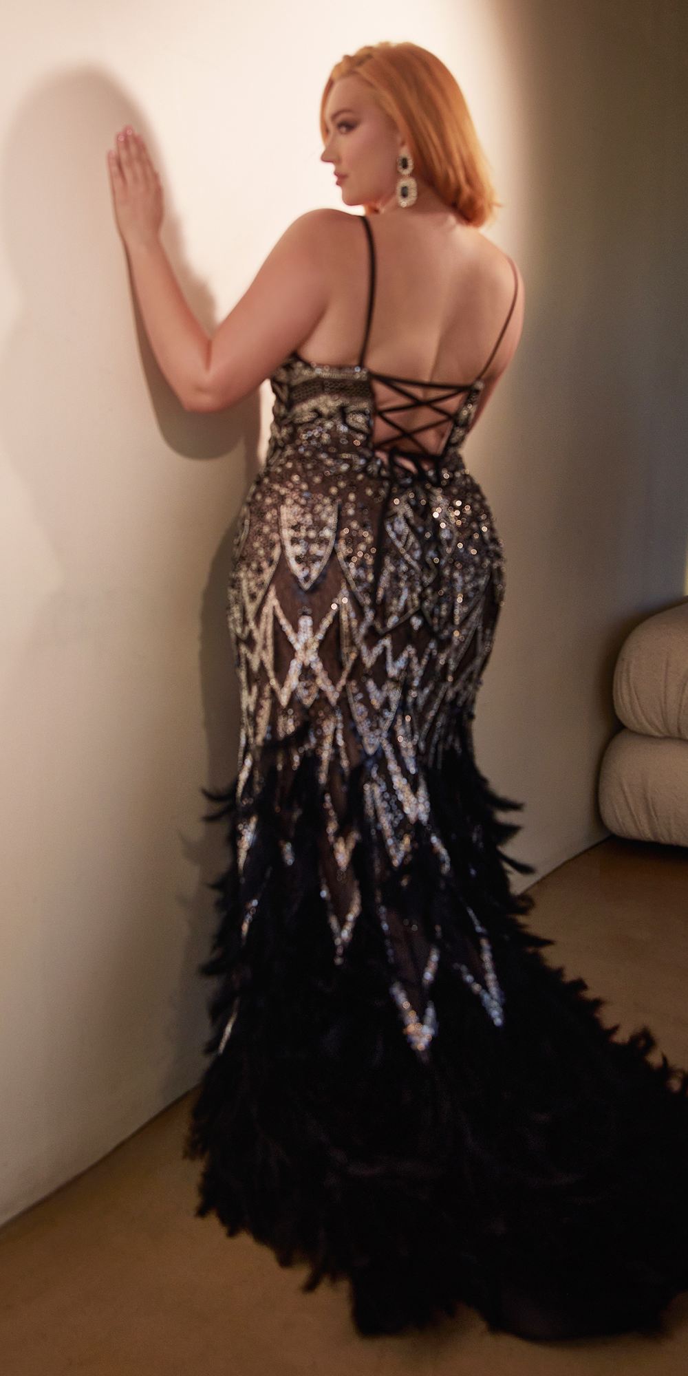 Black beaded mermaid gown with strappy back and feather fringe hem