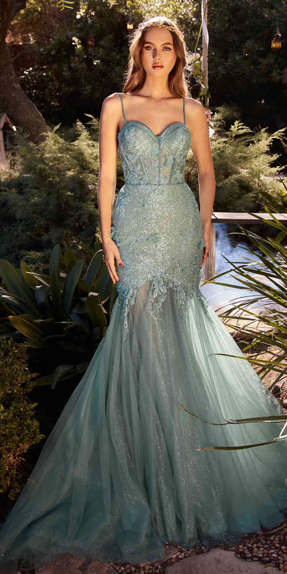 Teal glitter tulle trumpet gown with corset bodice, spaghetti straps, and flared hem