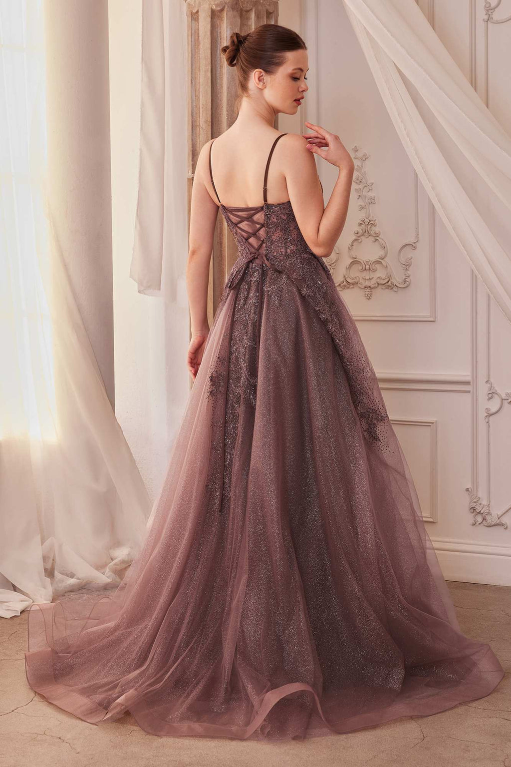Back of sparkly lace tulle A-line gown with open back and tiered long skirt