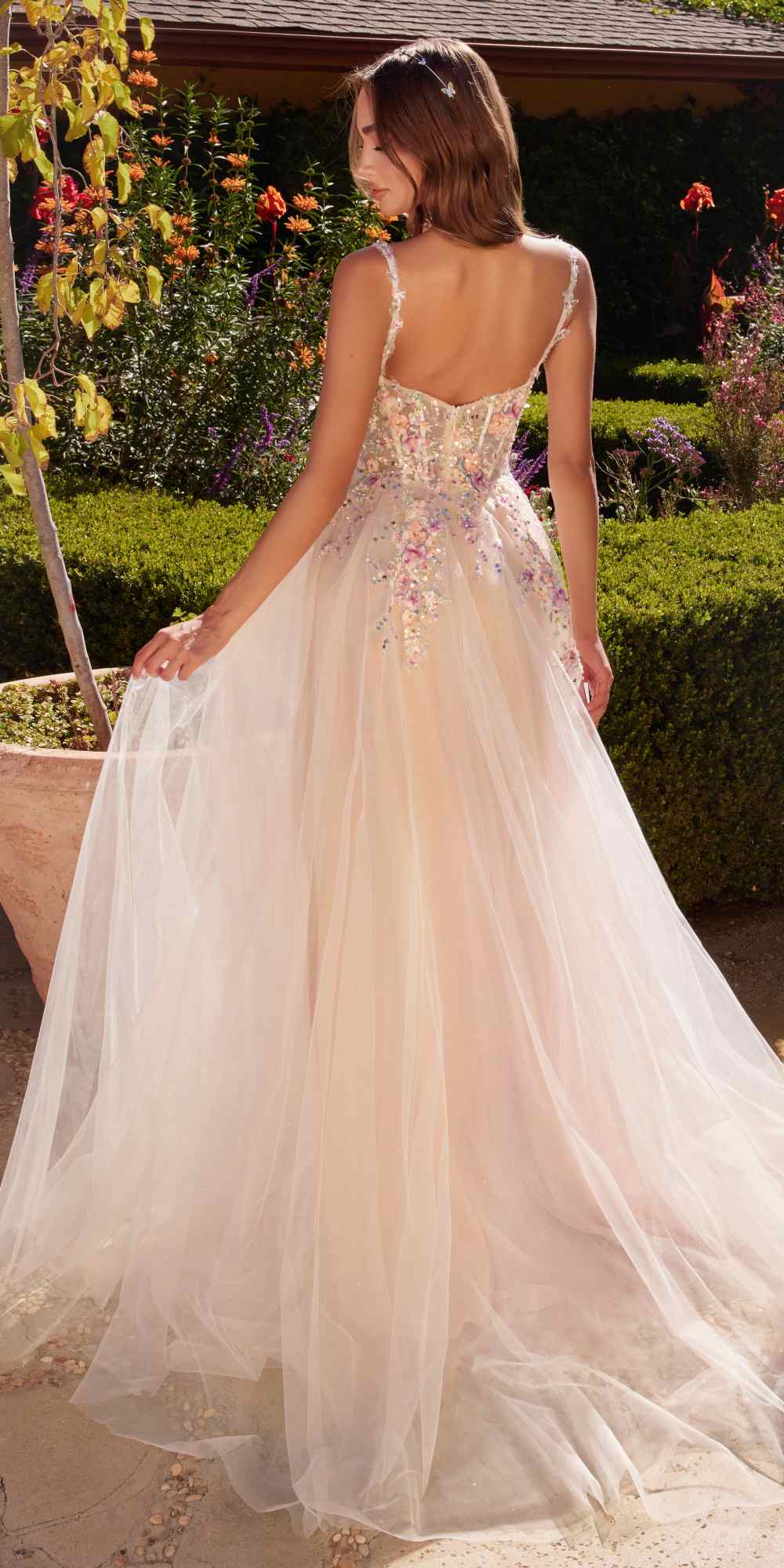 Back view long A-line dress in white with multicolored floral embellishments and thin straps