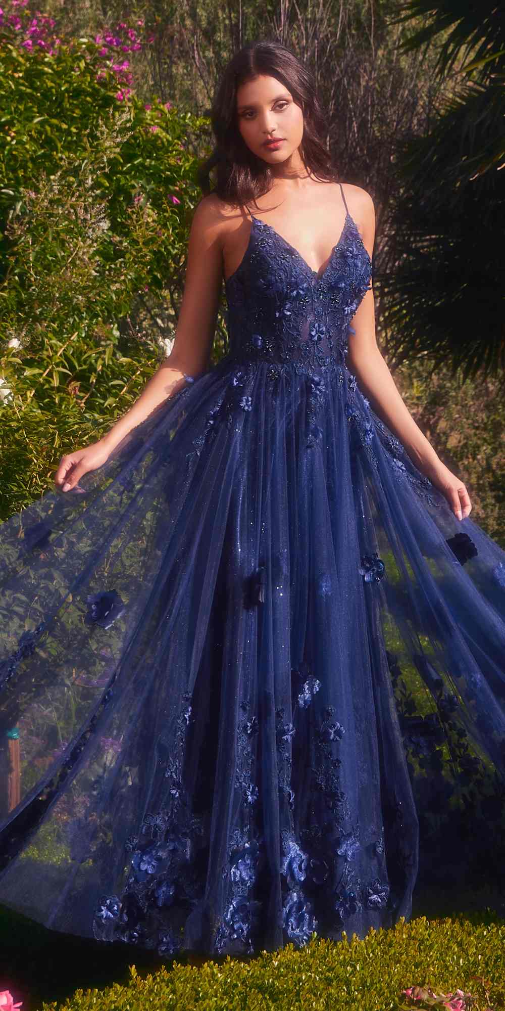 Navy blue A-line tulle gown with V-neck spaghetti straps and floral applique details