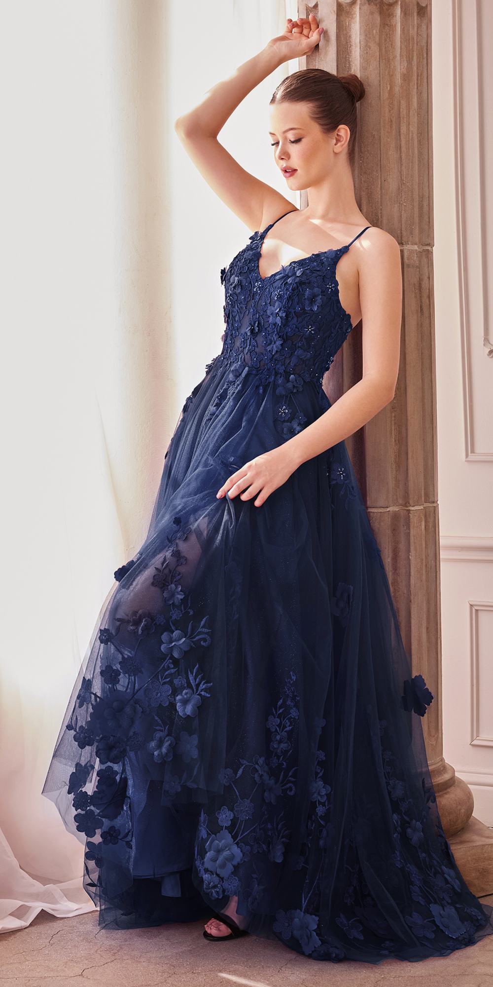 Navy blue A-line tulle gown with V-neck spaghetti straps and floral applique hem, sleeveless
