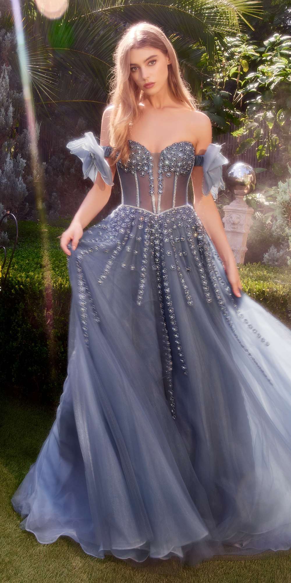 Midnight blue strapless beaded gown with corset bodice and bow arm bands, full tulle skirt.