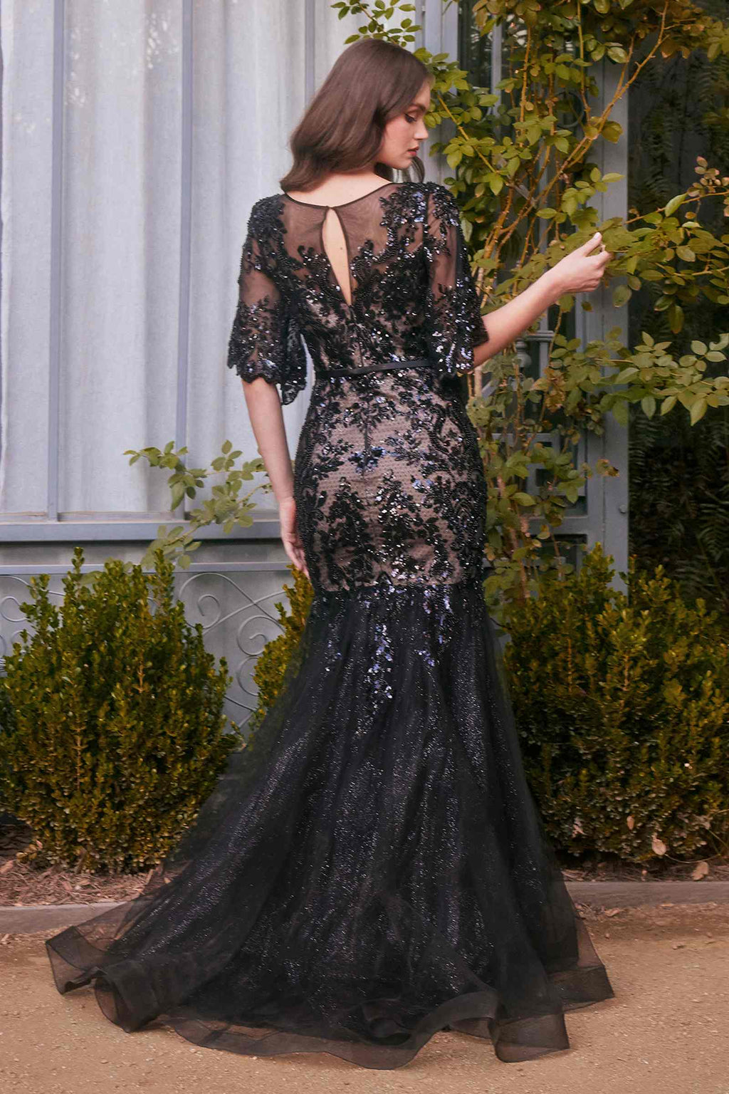 Black sequin mermaid gown with floral motif, open back and fitted silhouette