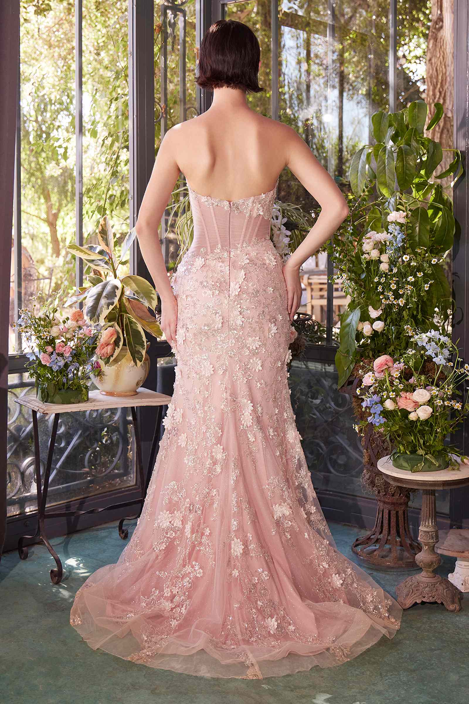 Blush pink sheer corset gown with open back, lace appliqués and front slit