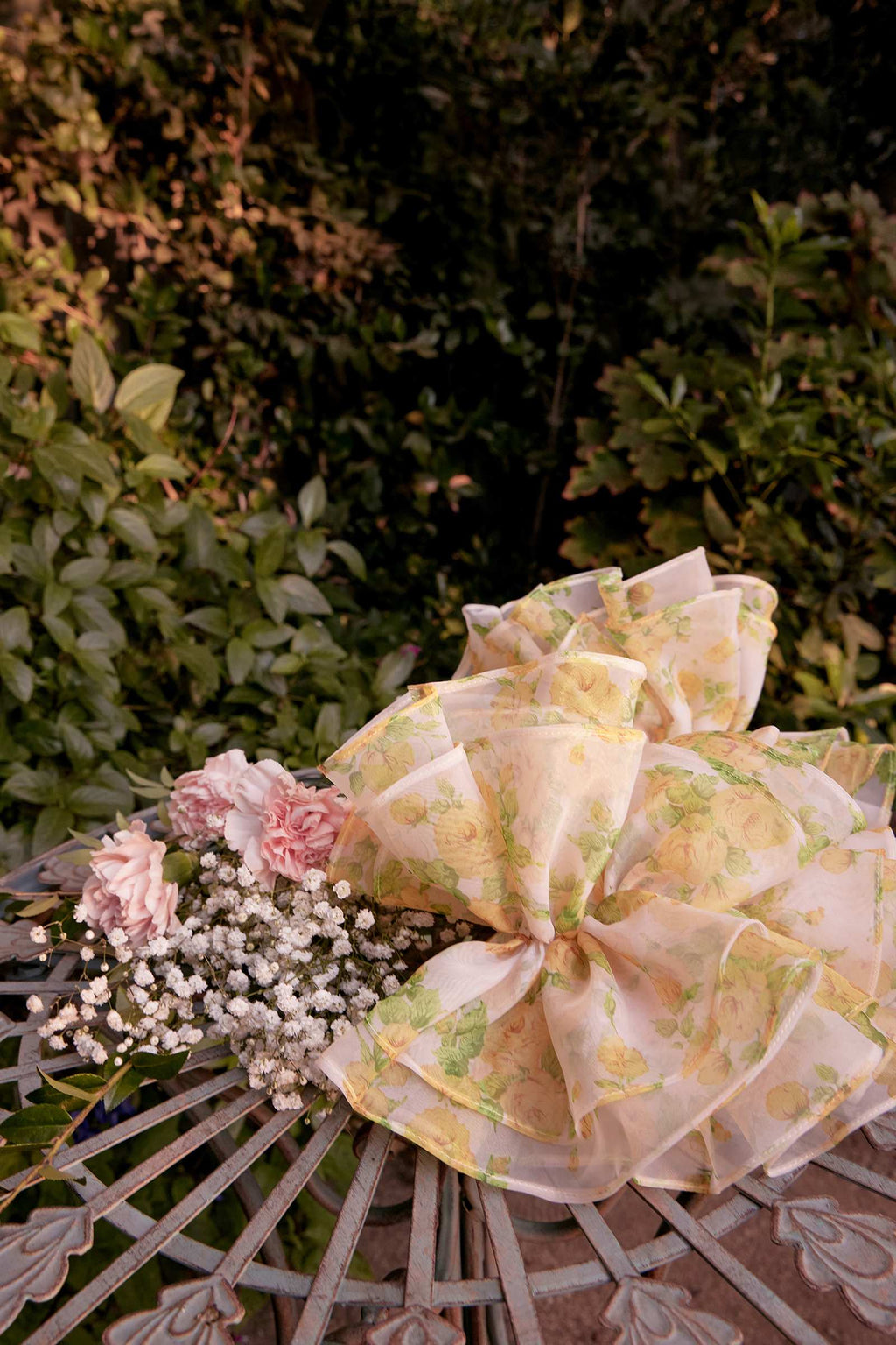 Yellow floral ball gown with bow detail and layered ruffled skirt