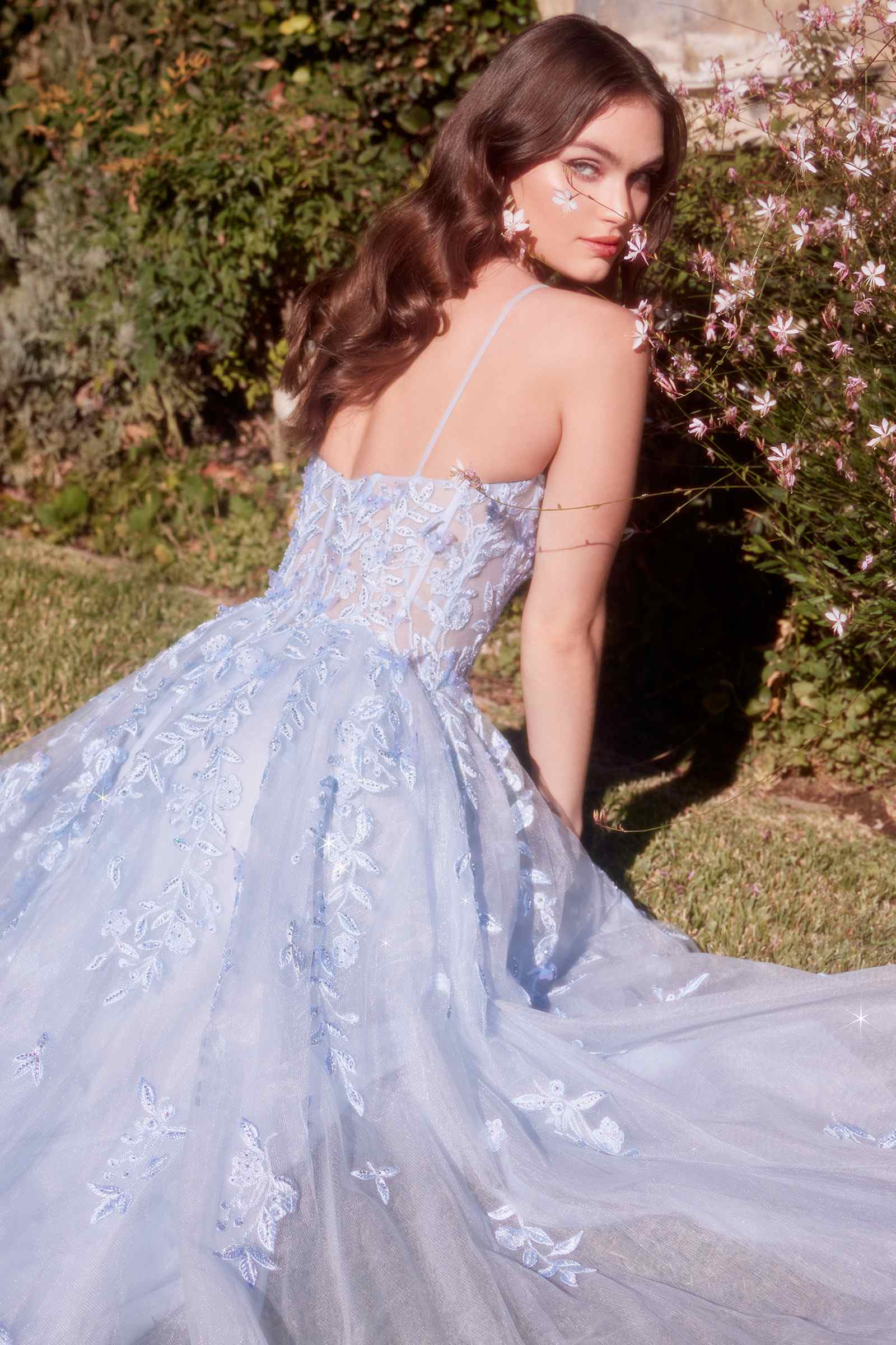 Light blue A-line appliqué gown with leaf motif, open-back straps, sheer tulle skirt detail