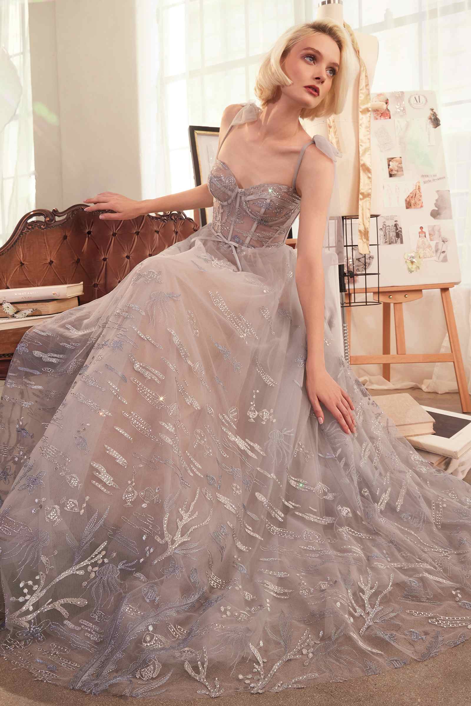 Silver A-line evening gown with fitted corset bodice, spaghetti straps, full skirt