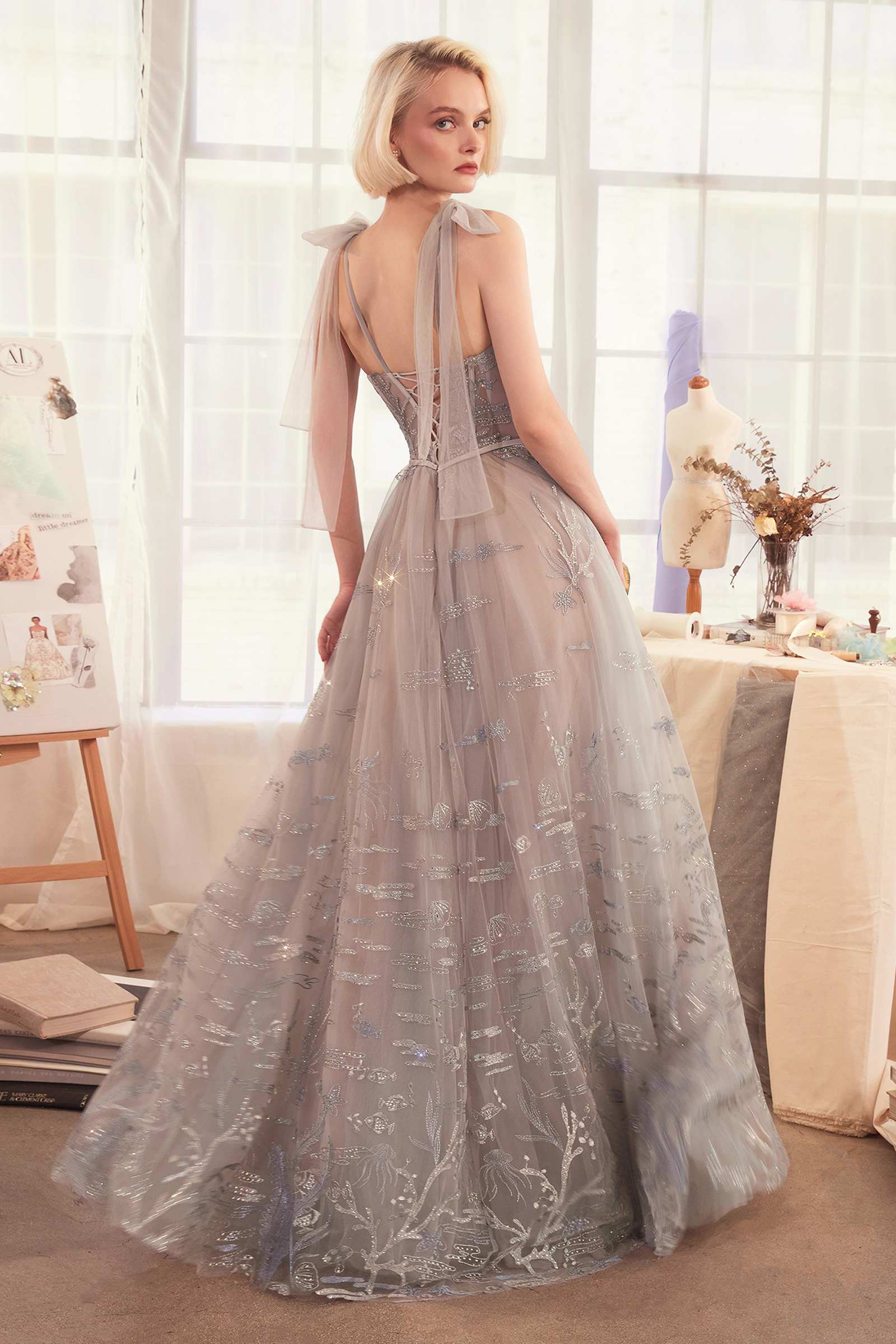 Silver A-line evening gown with spaghetti straps and an embroidered tulle skirt