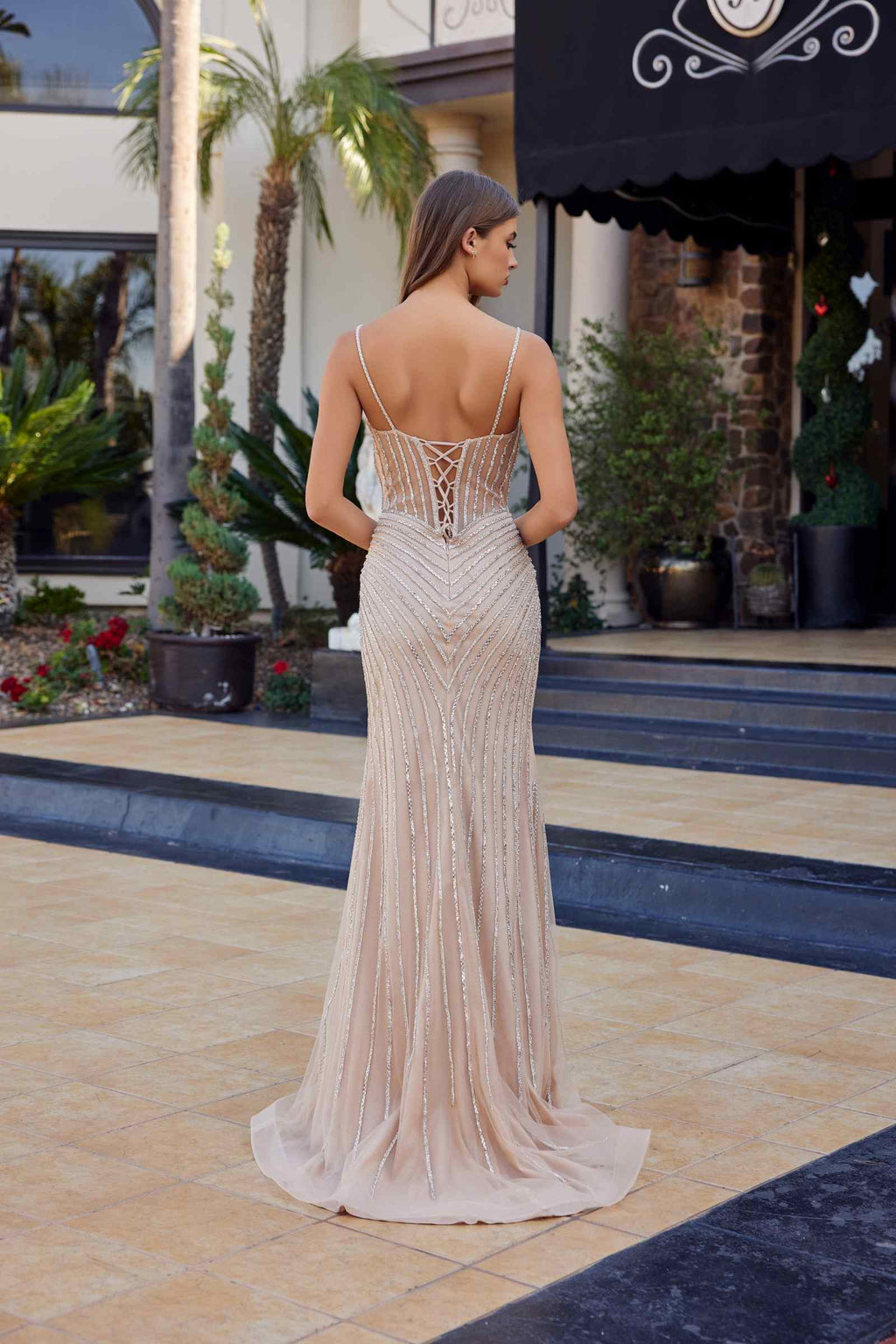 Champagne fitted tulle formal gown from back with open V-back and beaded pattern