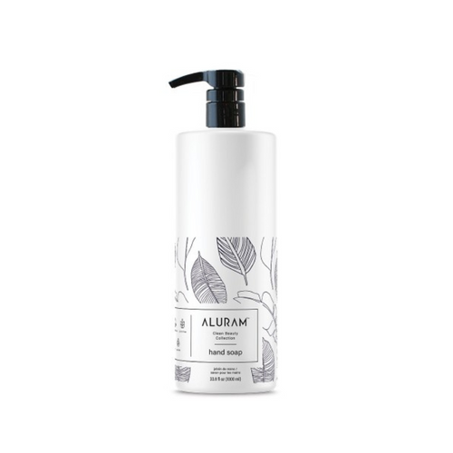 White hand soap bottle with black pump and Aluram leaf print label