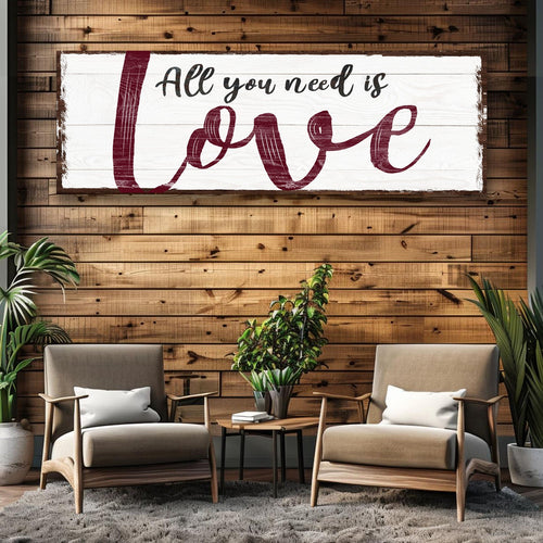 Framed wall canvas sign featuring burgundy “All you need is love” script text
