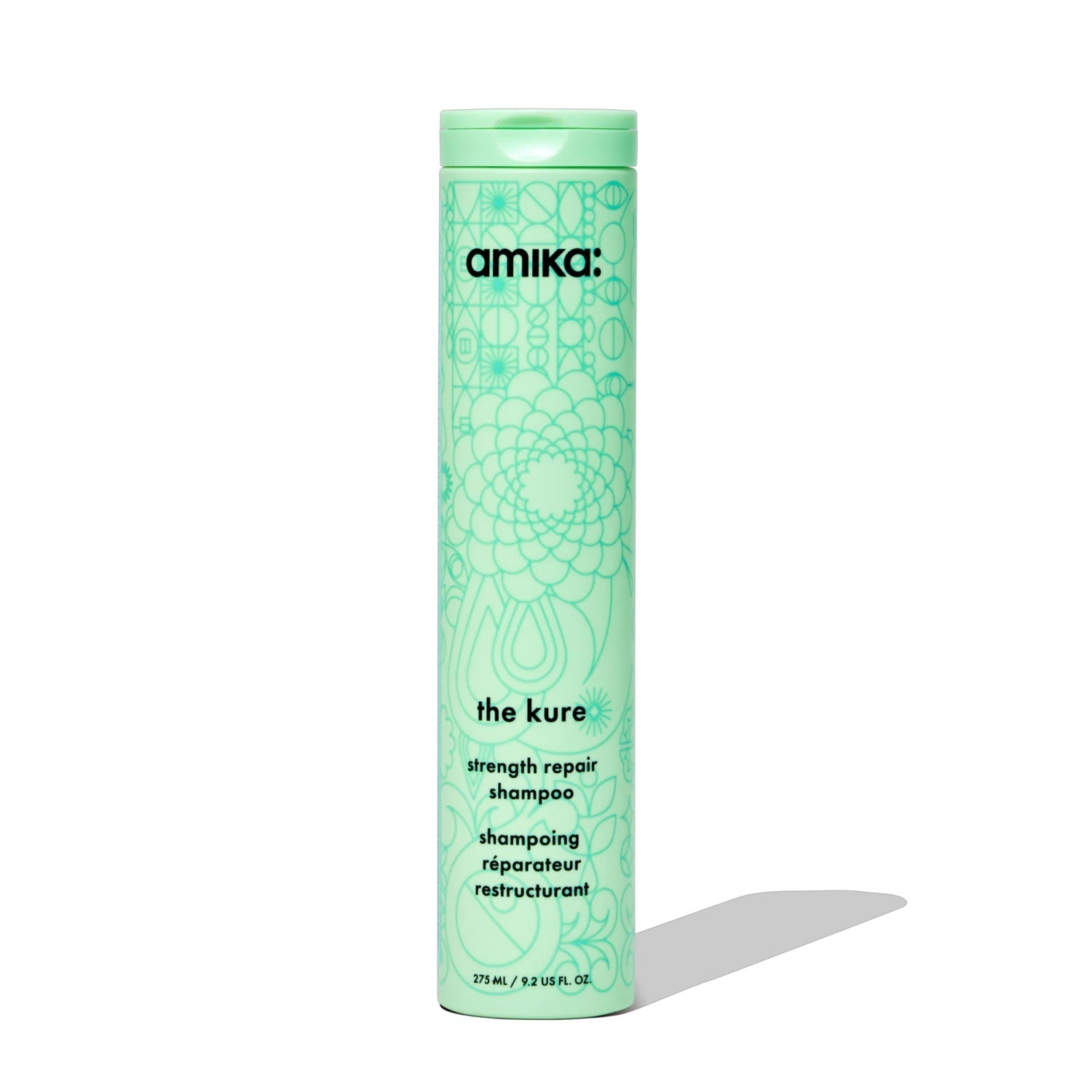 Strength repair shampoo bottle with green floral label and flip-top cap