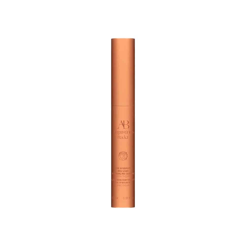 Augustinus Bader eyebrow and lash enhancing serum tube, slim cylindrical, amber-brown.