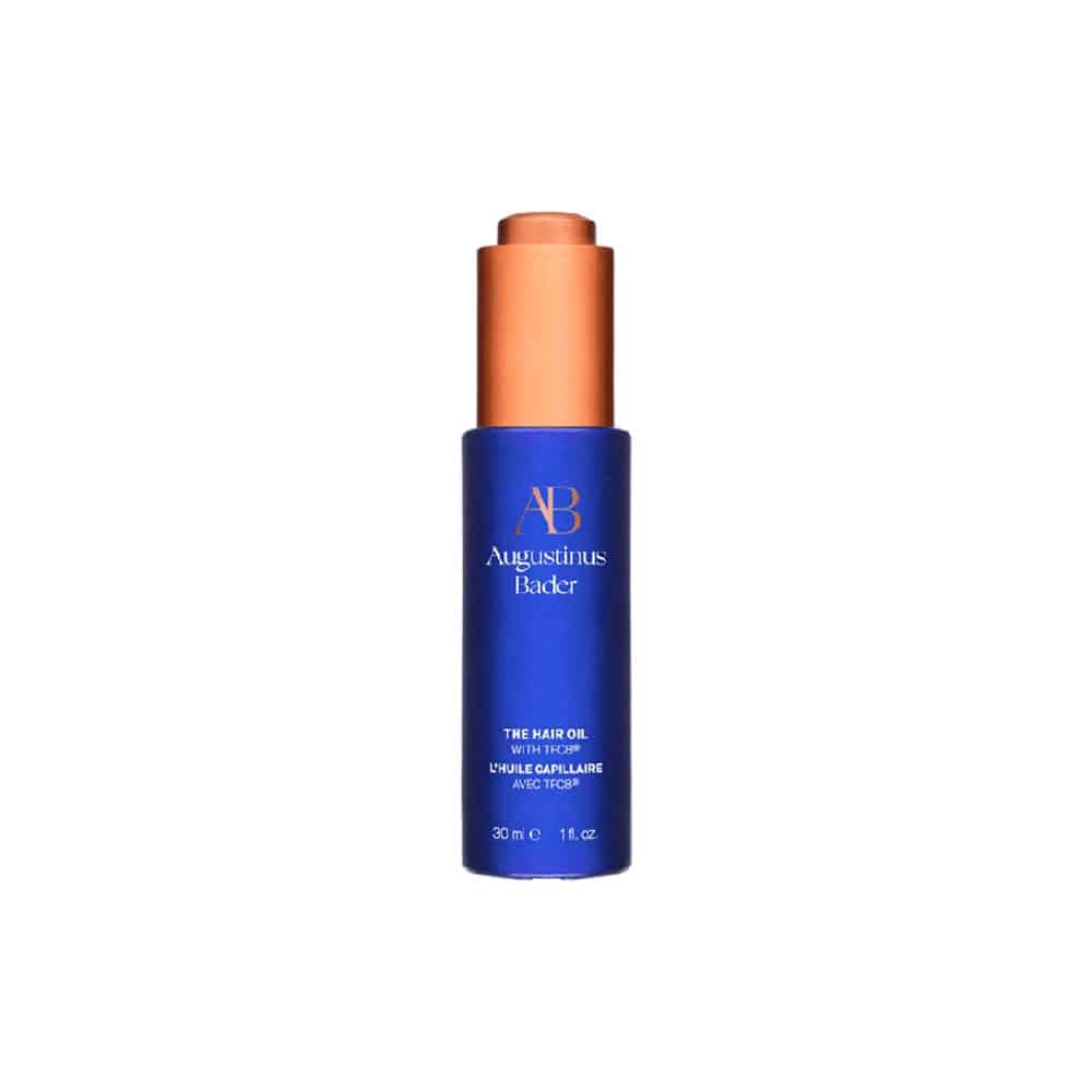 Augustinus Bader hair oil bottle, dark blue with orange cap, AB logo