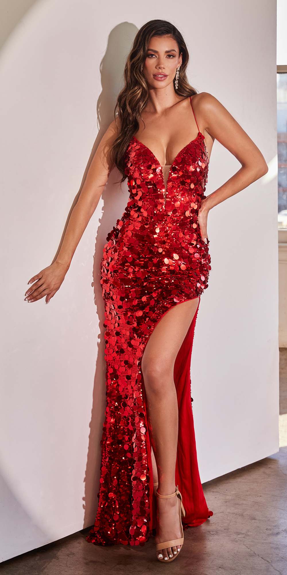 Red sequined V-neck fitted gown with thin straps and floor-length side slit