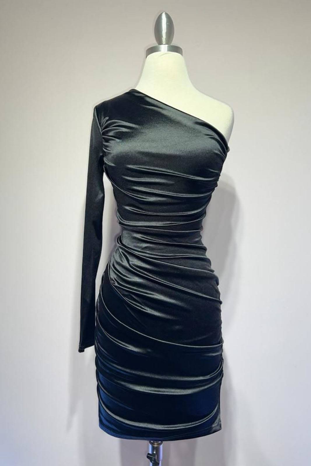 Black one-shoulder long-sleeve ruched cocktail dress on mannequin, draped neckline