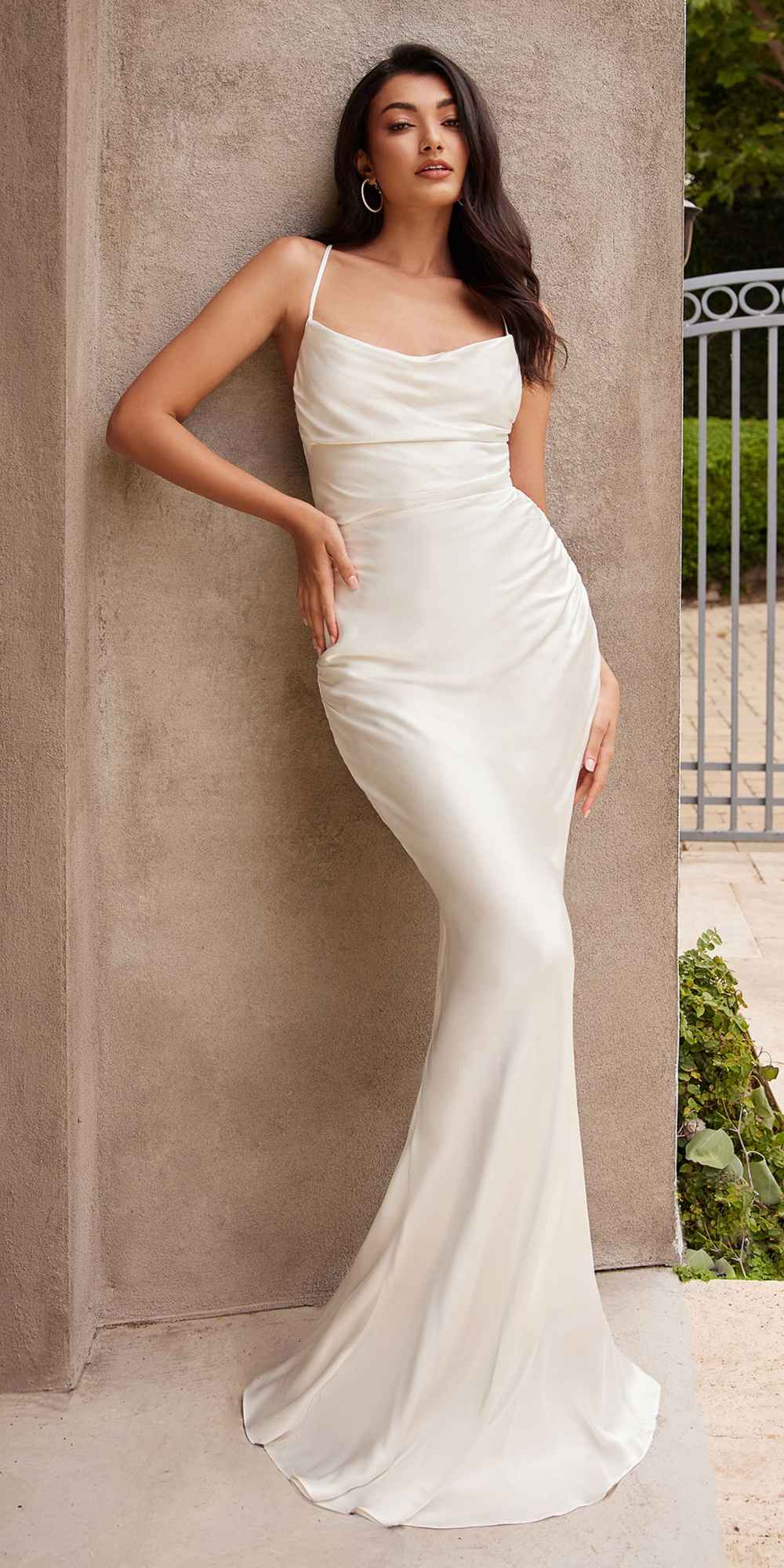 White satin slip gown with spaghetti straps, fitted mermaid silhouette.