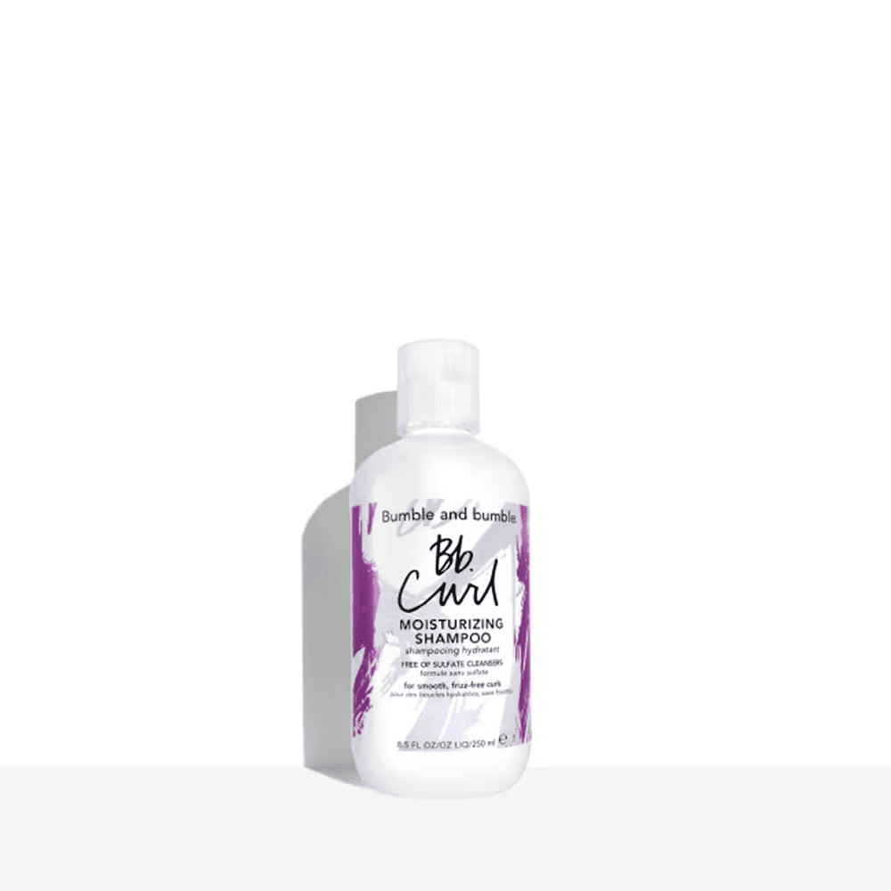 Moisturizing curl shampoo bottle with pump, white bottle and purple label