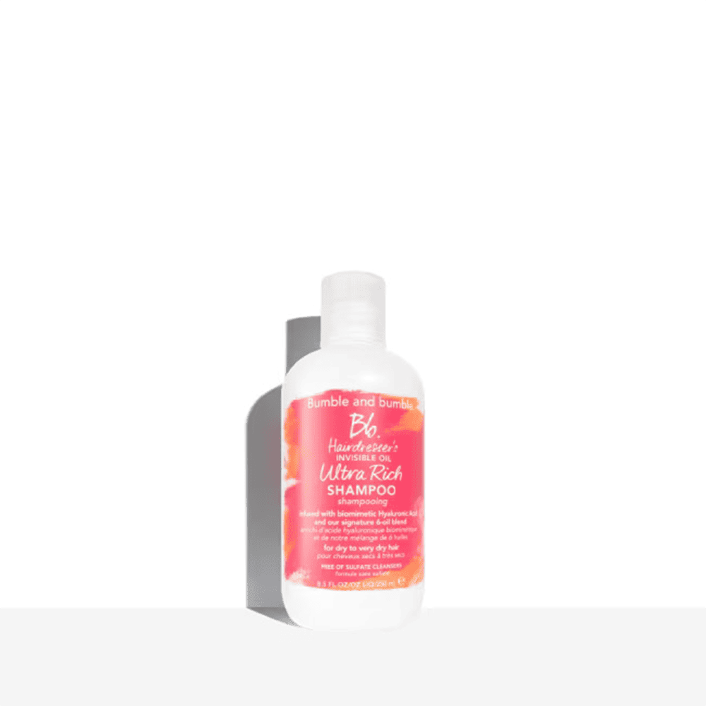 Shampoo bottle with white pump and orange-pink label, Bumble and bumble Ultra Rich