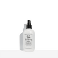 Bumble and bumble holding spray bottle with black pump, clear liquid